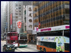 Double decked bus and trams passes along  Des Voeux Road.